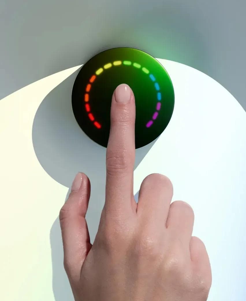 A patient's fingertip resting on the Prysm iO scanner during a 15-second wellness reading
